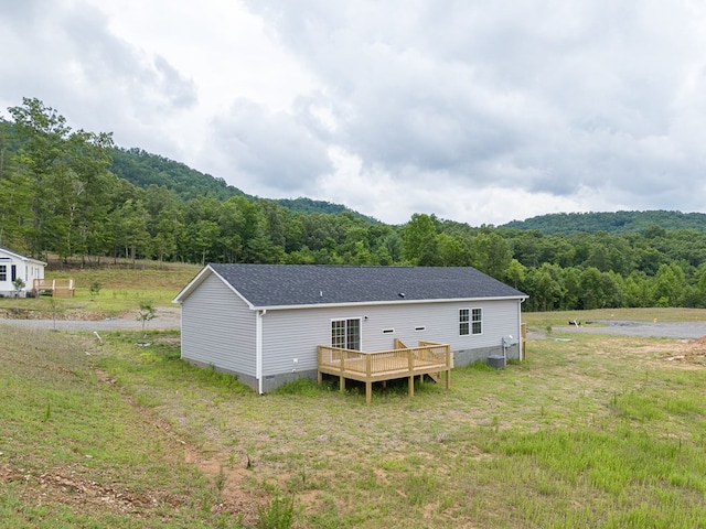 back of house featuring a wooden deck