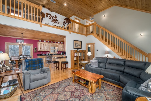 living room featuring wooden ceiling, stairway, an inviting chandelier, and wood finished floors