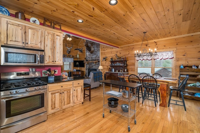 kitchen with wooden ceiling, appliances with stainless steel finishes, a chandelier, and light wood-style floors