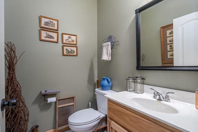 bathroom featuring toilet and vanity