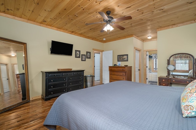 bedroom with baseboards, wood ceiling, ornamental molding, wood finished floors, and ensuite bathroom