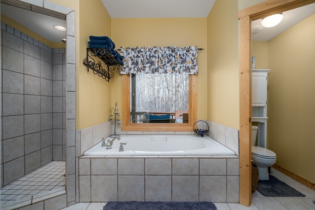 bathroom featuring tile patterned flooring, a garden tub, toilet, and tiled shower