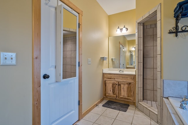 full bathroom with baseboards, vanity, a bath, and tile patterned floors