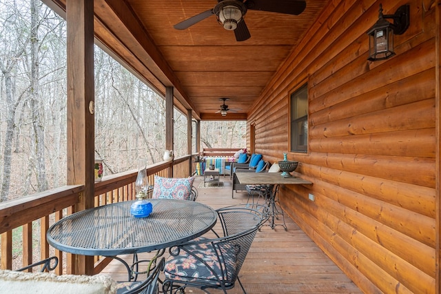 wooden terrace featuring a ceiling fan and outdoor dining area