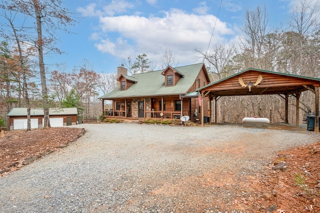 view of front of property with a porch, gravel driveway, an outdoor structure, and a chimney