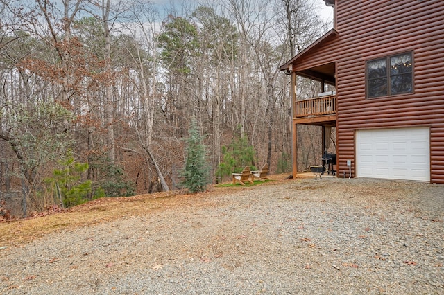 view of yard featuring driveway and a garage