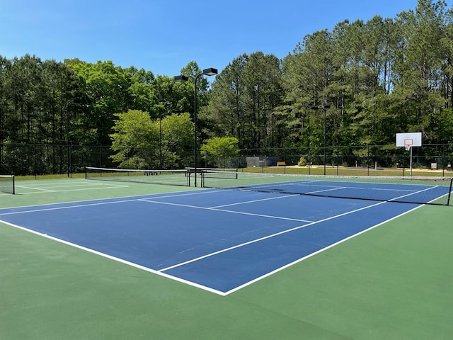 view of tennis court with fence