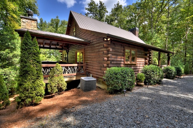 view of home's exterior with cooling unit and ceiling fan