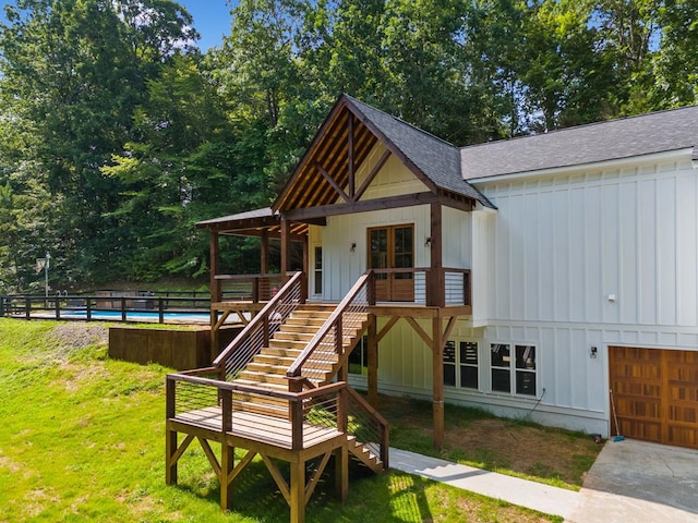 109 Lakeview Ct, Ellijay, GA 30540 - view of front of house featuring a shingled roof, board and batten siding, stairway, a garage, and a front lawn