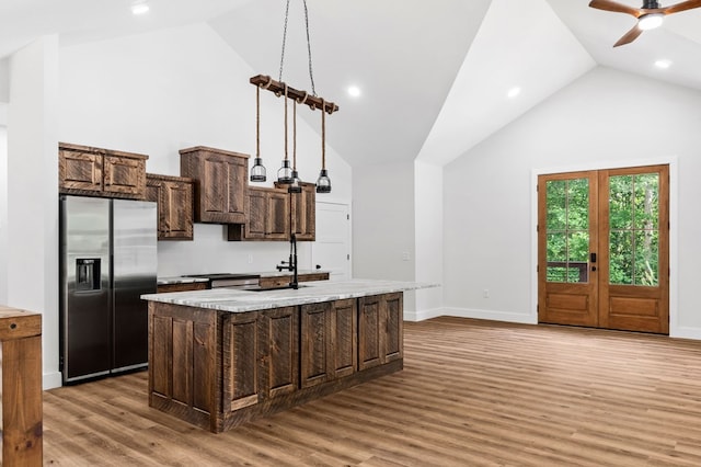 109 Lakeview Ct, Ellijay, GA 30540 - kitchen featuring stainless steel refrigerator with ice dispenser, an island with sink, light wood-style flooring, ceiling fan, and high vaulted ceiling