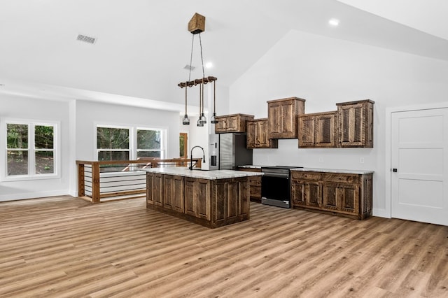 109 Lakeview Ct, Ellijay, GA 30540 - kitchen featuring stainless steel fridge with ice dispenser, electric stove, high vaulted ceiling, light wood-style floors, and a center island with sink