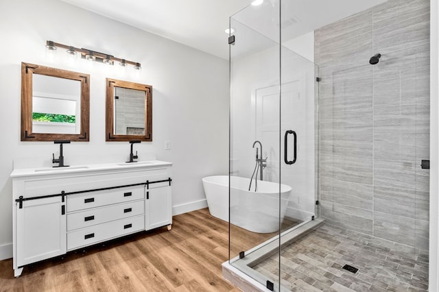 109 Lakeview Ct, Ellijay, GA 30540 - full bathroom with double vanity, a soaking tub, a shower stall, wood finished floors, and recessed lighting