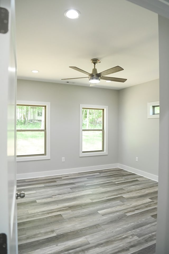 spare room featuring hardwood / wood-style flooring and ceiling fan