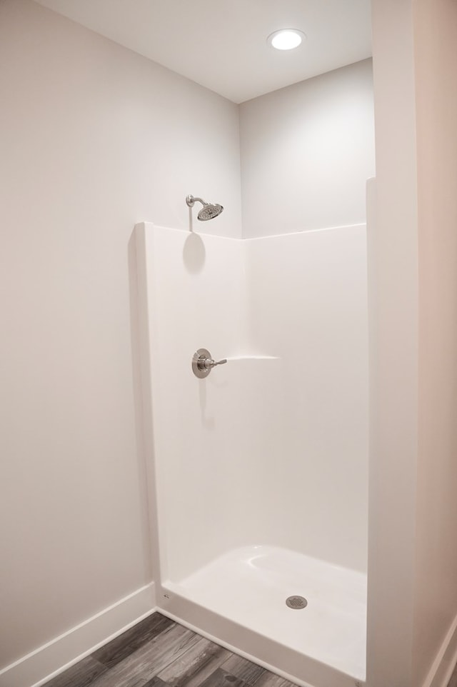 bathroom featuring a shower and hardwood / wood-style floors