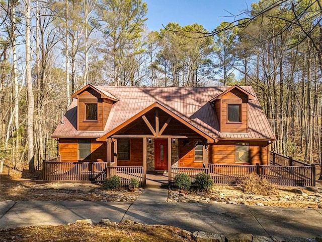 log-style house with covered porch