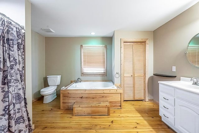 bathroom featuring hardwood / wood-style flooring, vanity, and toilet