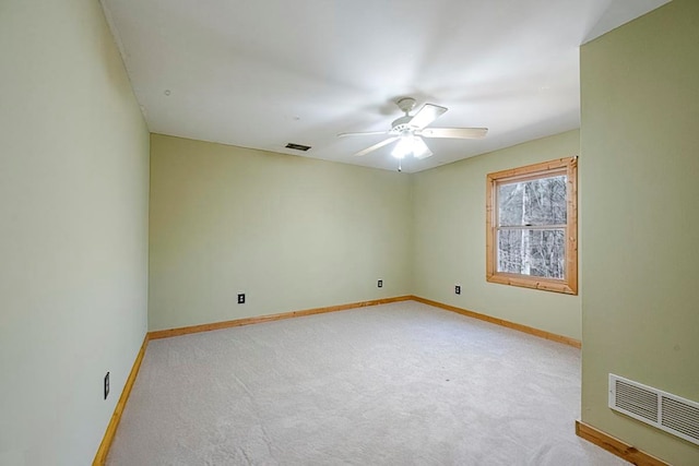 carpeted spare room with ceiling fan