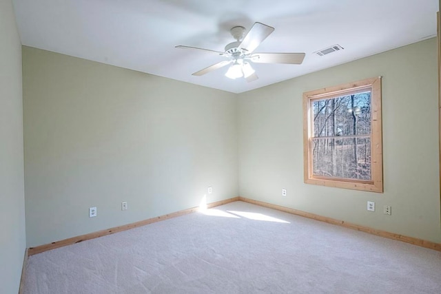 spare room featuring ceiling fan and light colored carpet