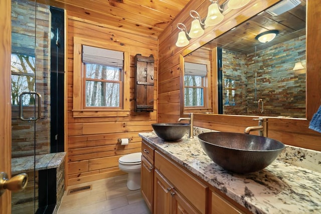 full bath with a sink, wooden walls, and wooden ceiling