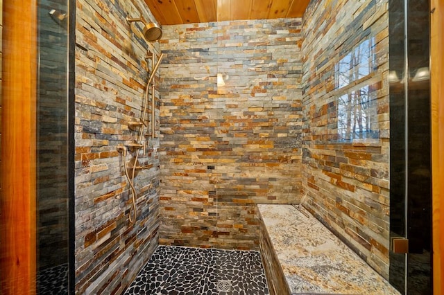 full bathroom with wood ceiling and a tile shower