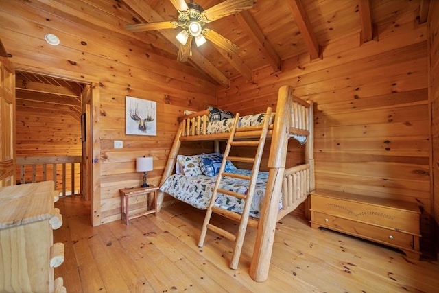 bedroom featuring light wood finished floors, wood walls, wood ceiling, and lofted ceiling with beams