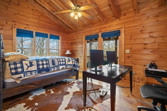 bedroom featuring wood ceiling, wood walls, vaulted ceiling with beams, and hardwood / wood-style floors