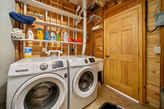 clothes washing area with tile patterned floors, laundry area, and washer and clothes dryer