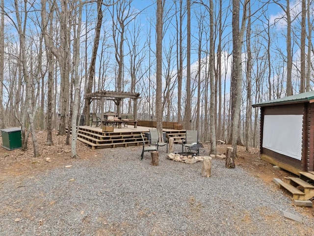 view of yard featuring a wooden deck and a pergola