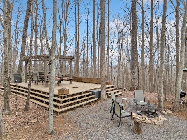 view of yard with an outdoor fire pit, a deck, and a pergola