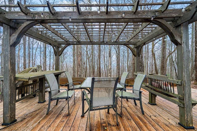 wooden terrace featuring outdoor dining space and a pergola