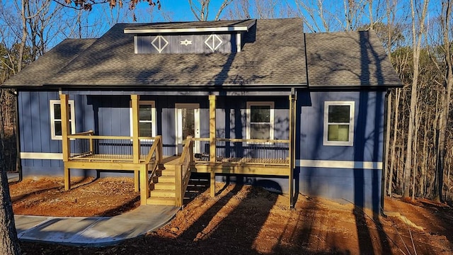 view of front facade featuring a porch and roof with shingles