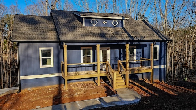 view of front of house with a porch and a shingled roof