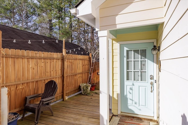 view of exterior entry with a wooden deck