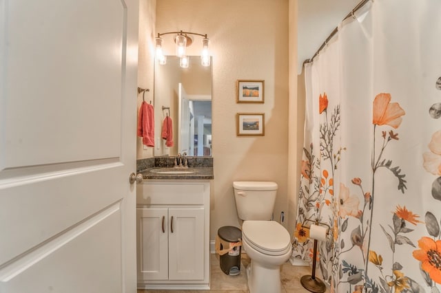 bathroom featuring vanity, toilet, and tile patterned floors