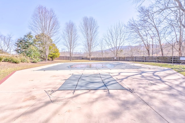 view of pool with a fenced in pool, a mountain view, fence, and a patio