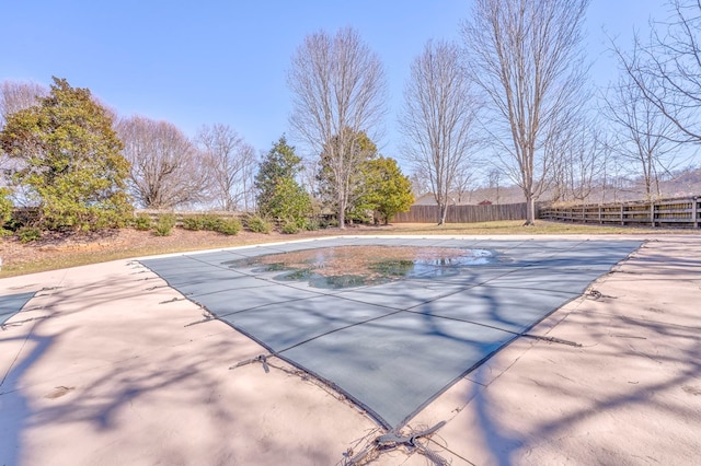 view of swimming pool with a fenced in pool and fence