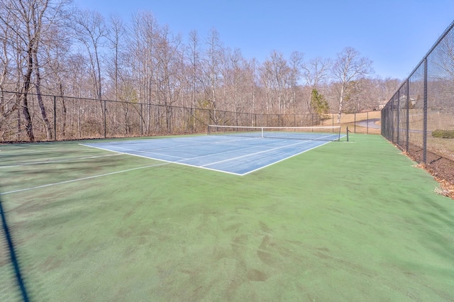 view of sport court featuring fence