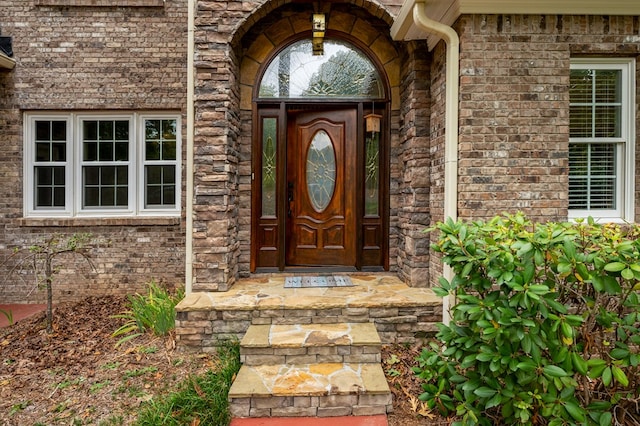 entrance to property with brick siding and stone siding