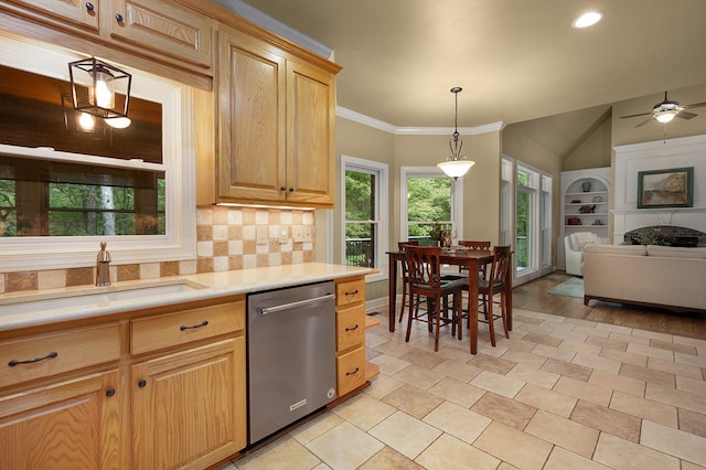 kitchen featuring built in shelves, open floor plan, light countertops, stainless steel dishwasher, and a sink