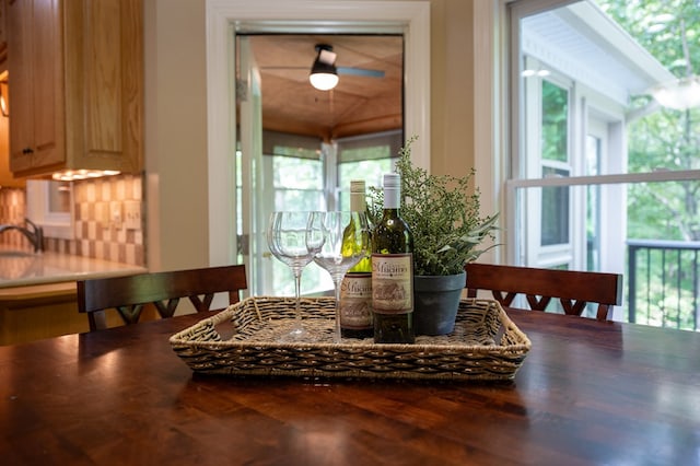 dining space featuring a wealth of natural light, wood finished floors, and vaulted ceiling