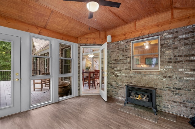 unfurnished sunroom featuring vaulted ceiling, wood ceiling, and ceiling fan