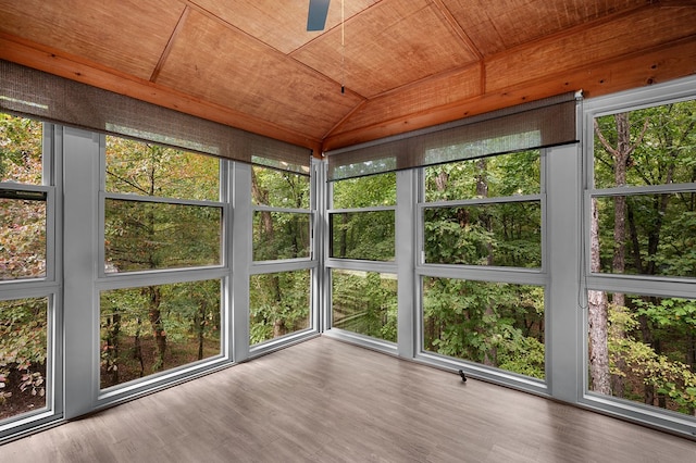 unfurnished sunroom featuring wood ceiling and a wealth of natural light