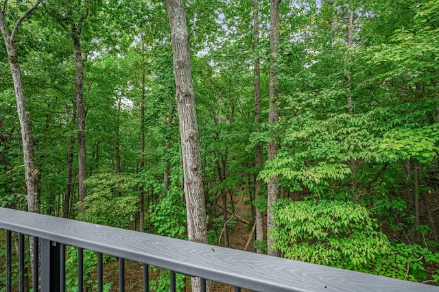 exterior space featuring a wooded view