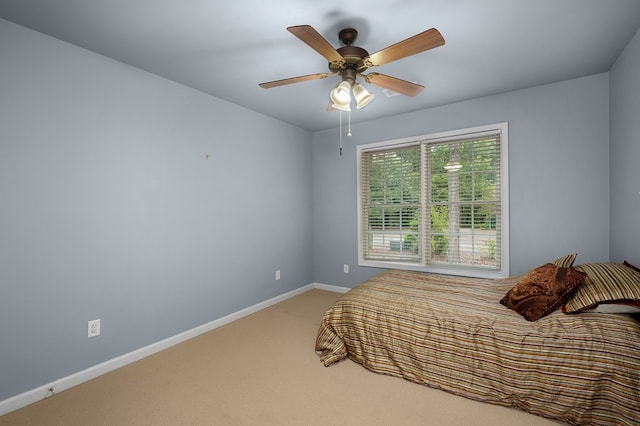 carpeted bedroom featuring a ceiling fan and baseboards