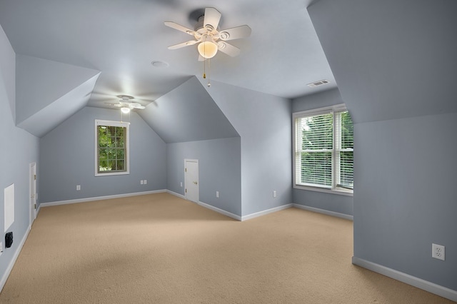 additional living space featuring visible vents, light carpet, and a healthy amount of sunlight