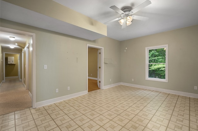 unfurnished room featuring baseboards and ceiling fan