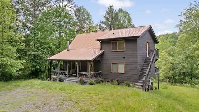 149 Happy Hollow Ln, Mineral Bluff, GA 30559 - view of front facade with covered porch, metal roof, and a front lawn