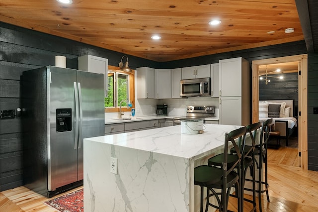 149 Happy Hollow Ln, Mineral Bluff, GA 30559 - kitchen with appliances with stainless steel finishes, a sink, light wood-type flooring, light stone countertops, and wooden ceiling