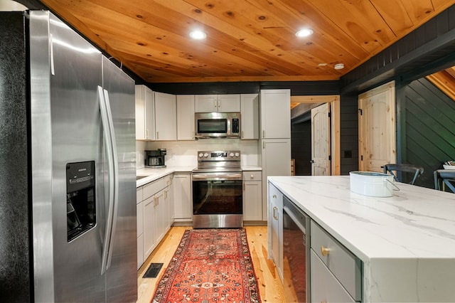 149 Happy Hollow Ln, Mineral Bluff, GA 30559 - kitchen with appliances with stainless steel finishes, beverage cooler, wooden ceiling, light wood finished floors, and light stone countertops