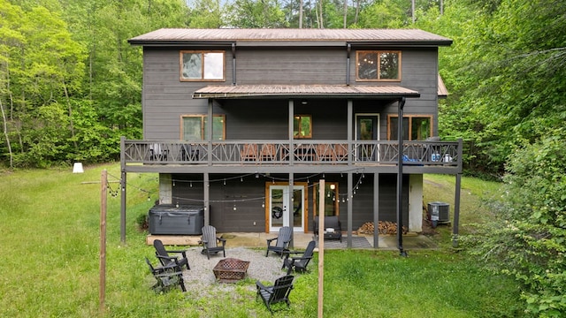 149 Happy Hollow Ln, Mineral Bluff, GA 30559 - rear view of property featuring a hot tub, an outdoor fire pit, a wooden deck, a patio area, and cooling unit